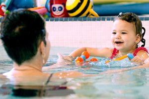 Parent in swimming pool with a child